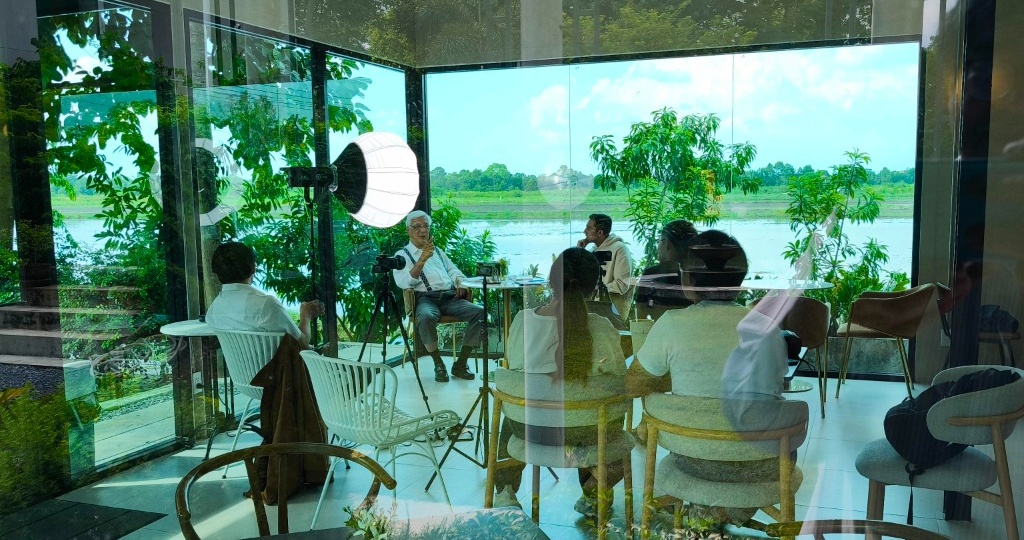 Chaloke Sambandaraksa interviewed by Sanjay Popli of AlphaMind overlooking the flooded paddy fields of Pathum Thani